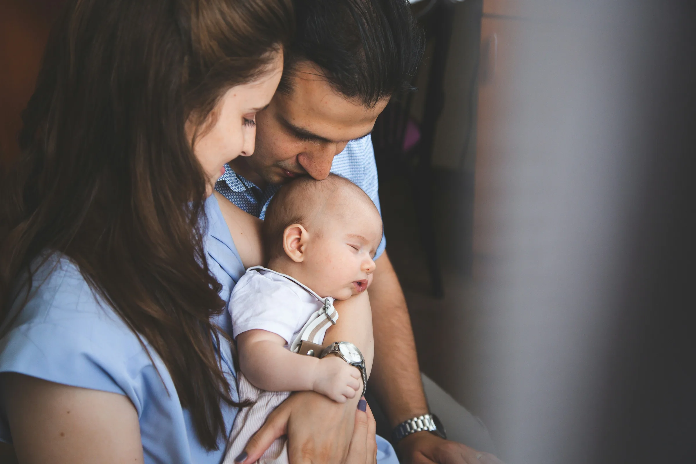 Mother and father holding a baby